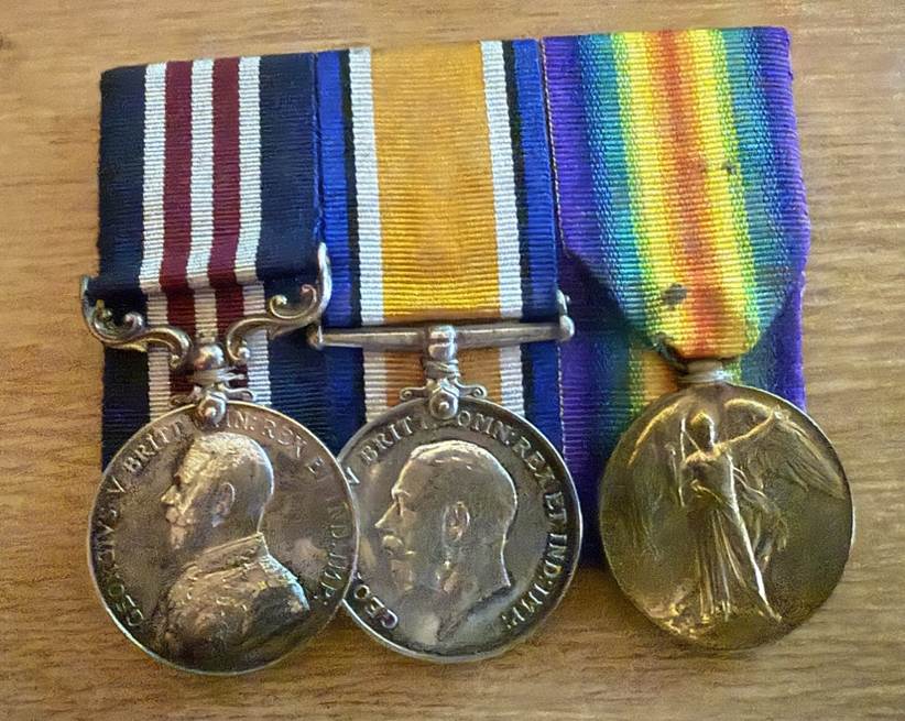A group of medals on a table

Description automatically generated